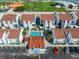 Aerial view of a community pool surrounded by well-maintained townhomes and parking at 230 Medallion Blvd # F, Madeira Beach, FL 33708