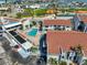 Overhead view of a community pool area surrounded by well-kept buildings and landscaping at 230 Medallion Blvd # F, Madeira Beach, FL 33708