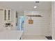 Bright kitchen with white cabinets, stainless steel appliances, and quartz countertops at 230 Medallion Blvd # F, Madeira Beach, FL 33708