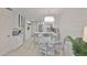 Bright kitchen with island, barstool seating, stainless appliances, and adjacent dining area at 230 Medallion Blvd # F, Madeira Beach, FL 33708