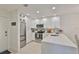Bright kitchen with white cabinets, stainless steel appliances, and a marble backsplash at 230 Medallion Blvd # F, Madeira Beach, FL 33708