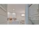 Bright kitchen features white cabinetry, quartz countertops, and stainless steel appliances at 230 Medallion Blvd # F, Madeira Beach, FL 33708