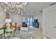 Living room featuring a stylish chandelier, comfortable seating, and a balcony at 230 Medallion Blvd # F, Madeira Beach, FL 33708
