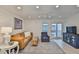 Well-lit living room featuring a ceiling fan, comfy sofa, and balcony access at 230 Medallion Blvd # F, Madeira Beach, FL 33708