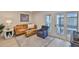 Nicely staged living room with comfy sofa and balcony access at 230 Medallion Blvd # F, Madeira Beach, FL 33708