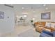 Open-concept living area featuring a dining table, kitchen, and comfy sofa at 230 Medallion Blvd # F, Madeira Beach, FL 33708