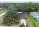 Aerial view showing a house with a long driveway and mature trees at 2410 Covington Ave, Spring Hill, FL 34608