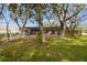 Lush backyard with a screened-in pool, offering privacy and relaxation at 2410 Covington Ave, Spring Hill, FL 34608