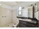Cozy bathroom with a vanity and tiled shower at 2410 Covington Ave, Spring Hill, FL 34608