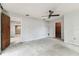 Large bedroom with ceiling fan, access to bathroom and walk-in closet at 2410 Covington Ave, Spring Hill, FL 34608
