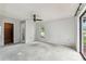 Spacious bedroom featuring a ceiling fan, and access to the outside at 2410 Covington Ave, Spring Hill, FL 34608