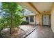 Inviting covered front patio with tiled floor, garden area, and natural light at 2410 Covington Ave, Spring Hill, FL 34608