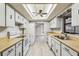 Bright kitchen with skylight, white cabinets, and appliances at 2410 Covington Ave, Spring Hill, FL 34608