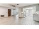 Bright, open-concept living space with modern tile flooring throughout the main floor at 2410 Covington Ave, Spring Hill, FL 34608