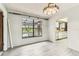 Bright, airy living room with new wood-look floors and a pool view at 2410 Covington Ave, Spring Hill, FL 34608