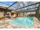 Sparkling pool inside a screened enclosure, creating a private backyard retreat at 2410 Covington Ave, Spring Hill, FL 34608