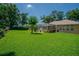 Expansive backyard with lush grass and a screened in pool area at 2417 Valrico Forest Dr, Valrico, FL 33594
