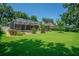 Manicured backyard featuring a screened in pool and mature shade trees at 2417 Valrico Forest Dr, Valrico, FL 33594