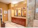Bathroom featuring double sinks with granite countertops and a tiled shower at 2417 Valrico Forest Dr, Valrico, FL 33594