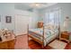 Bedroom showcasing natural light, wood floors, and a neutral color palette at 2417 Valrico Forest Dr, Valrico, FL 33594