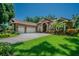 Beautiful home featuring lush landscaping, a three car garage, and an inviting front yard at 2417 Valrico Forest Dr, Valrico, FL 33594