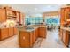 Spacious kitchen featuring granite countertops, wood cabinetry, and stainless appliances at 2417 Valrico Forest Dr, Valrico, FL 33594