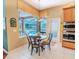 Cozy breakfast nook area with views of the screened in lanai, pool, and backyard at 2417 Valrico Forest Dr, Valrico, FL 33594