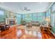 Bright living room featuring hardwood floors, a fireplace, and large windows at 2417 Valrico Forest Dr, Valrico, FL 33594
