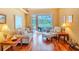 Bright living room with sliding glass doors, hardwood flooring, and cozy furniture at 2417 Valrico Forest Dr, Valrico, FL 33594