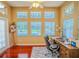 Bright home office with desk, chair, and windows overlooking pool at 2417 Valrico Forest Dr, Valrico, FL 33594