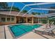 Backyard pool featuring sun loungers and a relaxing outdoor seating area at 2417 Valrico Forest Dr, Valrico, FL 33594