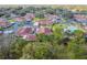 Aerial view showcases community with pool, verdant greenery, and well-maintained homes at 2444 Laurelwood Dr # A, Clearwater, FL 33763