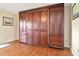 Bright bedroom featuring a built-in wall unit with abundant storage and rich wood accents at 2444 Laurelwood Dr # A, Clearwater, FL 33763