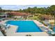Large community pool surrounded by lounge chairs and well-maintained landscaping at 2444 Laurelwood Dr # A, Clearwater, FL 33763