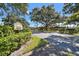 Inviting Laurelwood Condominiums entrance boasts mature trees and manicured landscaping for a serene welcome at 2444 Laurelwood Dr # A, Clearwater, FL 33763