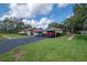 Exterior view of home with carport and tidy landscaping on a sunny day at 2444 Laurelwood Dr # A, Clearwater, FL 33763