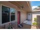 Charming front porch with a cozy seating area, a red front door, and decorative landscaping at 2444 Laurelwood Dr # A, Clearwater, FL 33763