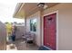 Inviting front porch with two chairs, plants, and a red front door, creating a warm welcome at 2444 Laurelwood Dr # A, Clearwater, FL 33763