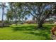 Beautifully landscaped front yard with mature trees providing shade and curb appeal at 2444 Laurelwood Dr # A, Clearwater, FL 33763
