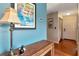 Hallway with wood look flooring, decorative accents, and direct access to front door at 2444 Laurelwood Dr # A, Clearwater, FL 33763