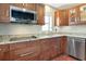Well-equipped kitchen featuring wood cabinets, granite countertops, and stainless steel appliances at 2444 Laurelwood Dr # A, Clearwater, FL 33763