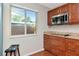Kitchen featuring wood cabinets, granite countertops, and stainless steel appliances, bathed in natural light at 2444 Laurelwood Dr # A, Clearwater, FL 33763