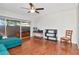 Bright living room offers ceiling fan, slider to lanai, and hardwood floors at 2444 Laurelwood Dr # A, Clearwater, FL 33763