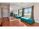 Spacious living room with a mirrored wall reflecting a comfortable seating area and plenty of natural light at 2444 Laurelwood Dr # A, Clearwater, FL 33763