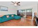 Relaxing living room with comfortable seating, slider to lanai, and wood-look flooring at 2444 Laurelwood Dr # A, Clearwater, FL 33763