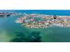 Breathtaking aerial of this waterfront property, beach, and marina with serene ocean views at 253 Boca Ciega Dr, Madeira Beach, FL 33708