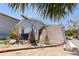 Home's exterior featuring a hurricane-damaged fence, palm trees, and utility equipment at 253 Boca Ciega Dr, Madeira Beach, FL 33708