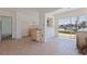 Spacious kitchen area featuring tile flooring, bright light, and marina views at 253 Boca Ciega Dr, Madeira Beach, FL 33708