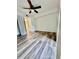 Spacious bedroom with hardwood flooring, ceiling fan, and bright natural lighting at 2690 Coral Landings Blvd # 217, Palm Harbor, FL 34684