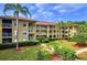 Well maintained condo complex with lush landscaping, benches, and palm trees offering a relaxing environment at 2690 Coral Landings Blvd # 217, Palm Harbor, FL 34684